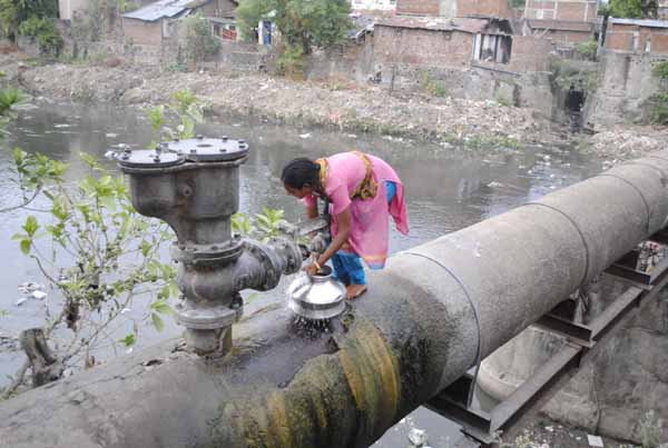 In the troubled waters… Residents on Nandanwan road are left with no option but to rely on trunk line leakage for fulfilling their water needs.